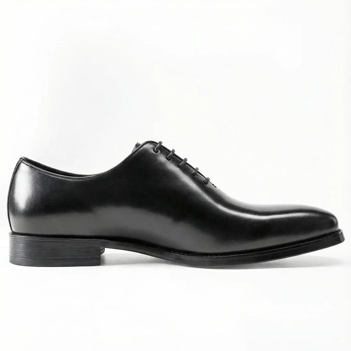 Classic black leather oxford dress shoe with closed lacing on white background