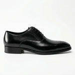 Load image into Gallery viewer, Black leather Oxford dress shoe with brogue detailing on toe, side view, white background.