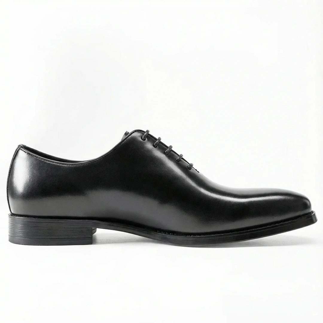 Classic black leather Oxford dress shoe with closed lacing on white background